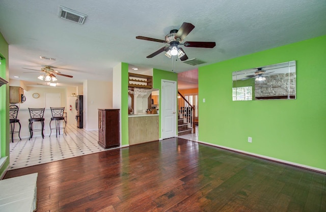15731 Oak Mountain Dr, Houston, TX 77095 - unfurnished living room featuring ceiling fan, wood finished floors, and stairs