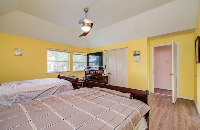 15731 Oak Mountain Dr, Houston, TX 77095 - bedroom with wood finished floors, a ceiling fan, and vaulted ceiling