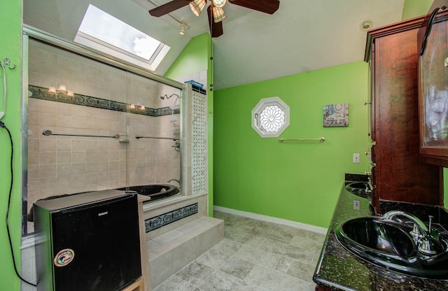 15731 Oak Mountain Dr, Houston, TX 77095 - bathroom with a ceiling fan, a skylight, vaulted ceiling, double vanity, and tiled shower / bath