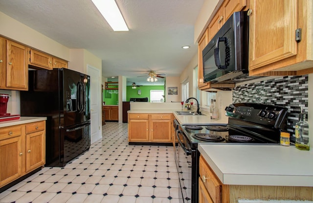15731 Oak Mountain Dr, Houston, TX 77095 - kitchen with black appliances, a peninsula, light flooring, light countertops, and a ceiling fan
