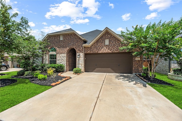 2922 Muhley St, Katy, TX 77493 - view of front facade featuring brick siding, driveway, a garage, and a front lawn