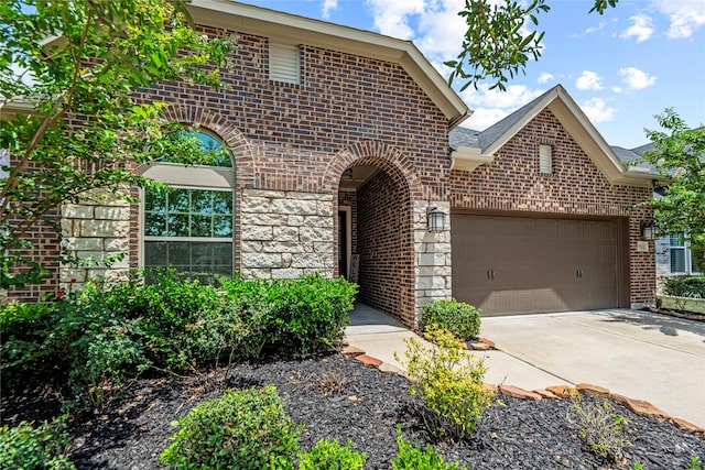 2922 Muhley St, Katy, TX 77493 - view of front facade with brick siding, an attached garage, and driveway