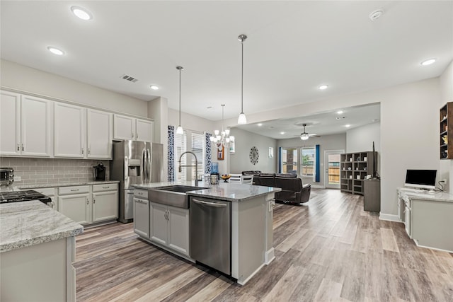 2922 Muhley St, Katy, TX 77493 - kitchen with stainless steel appliances, light wood-type flooring, light stone countertops, pendant lighting, and recessed lighting