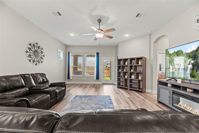 2922 Muhley St, Katy, TX 77493 - living area featuring ceiling fan, light wood-style flooring, recessed lighting, and a glass covered fireplace