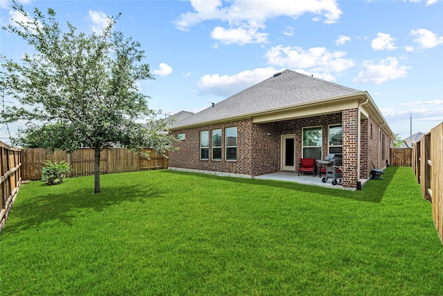 2922 Muhley St, Katy, TX 77493 - rear view of house featuring a patio, a fenced backyard, brick siding, and a shingled roof