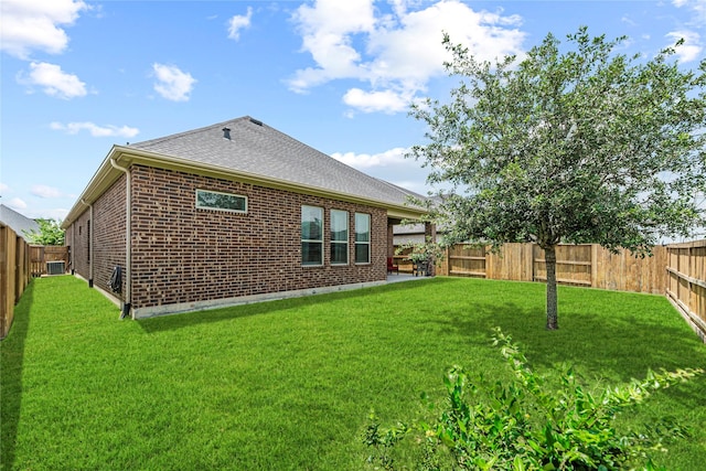 2922 Muhley St, Katy, TX 77493 - back of house featuring a fenced backyard, brick siding, and a shingled roof