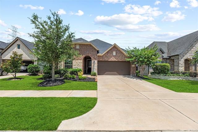 2922 Muhley St, Katy, TX 77493 - view of front facade featuring a garage, a front yard, driveway, and brick siding