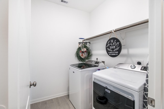 8023 Royal Palm Dr, Fulshear, TX 77441 - laundry room featuring washer and clothes dryer and light wood-style floors
