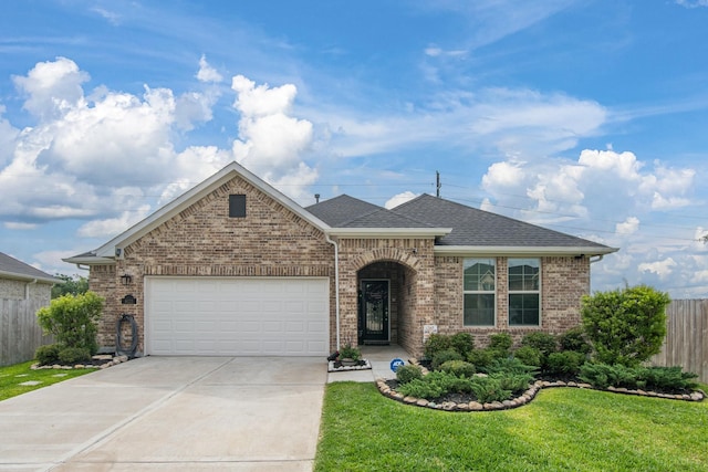 8023 Royal Palm Dr, Fulshear, TX 77441 - view of front facade featuring driveway, an attached garage, brick siding, and roof with shingles