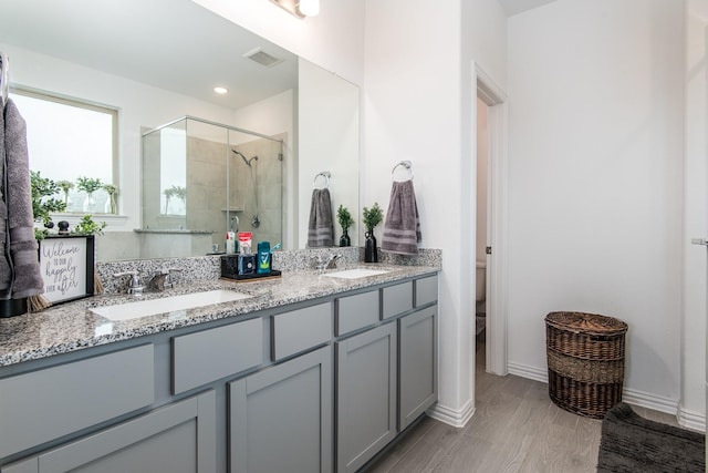 8023 Royal Palm Dr, Fulshear, TX 77441 - full bathroom featuring a shower stall, double vanity, and wood finished floors