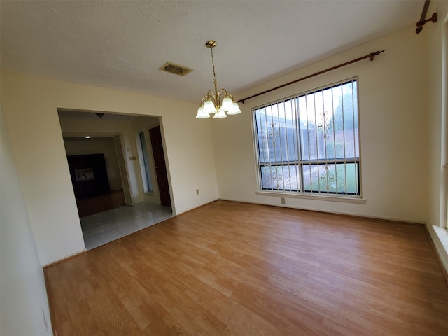 9206 Beringwood Dr, Houston, TX 77083 - unfurnished room with light wood-style floors and a chandelier