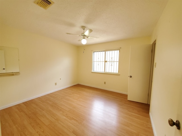 9206 Beringwood Dr, Houston, TX 77083 - empty room with a ceiling fan, light wood-style floors, and a textured ceiling