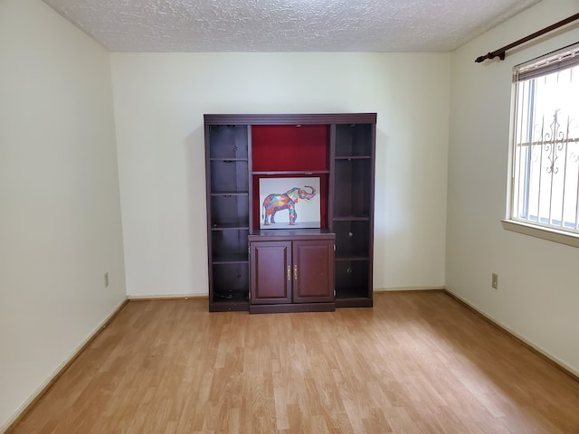 9206 Beringwood Dr, Houston, TX 77083 - empty room featuring light wood-style floors and a textured ceiling
