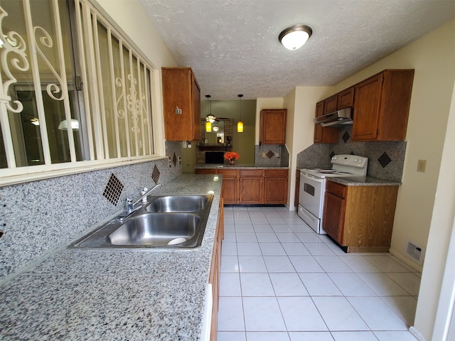 9206 Beringwood Dr, Houston, TX 77083 - kitchen with white electric stove, brown cabinets, tasteful backsplash, under cabinet range hood, and a textured ceiling