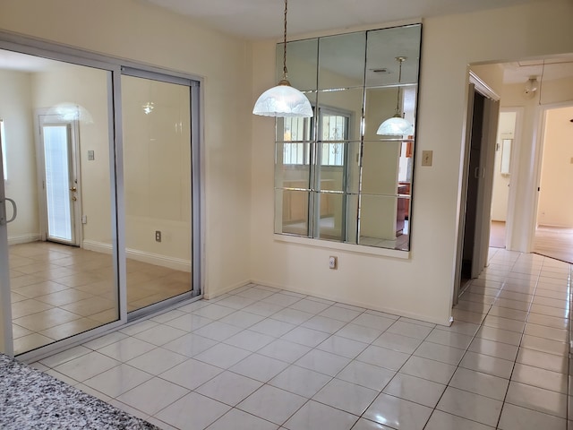 9206 Beringwood Dr, Houston, TX 77083 - unfurnished dining area with light tile patterned flooring and baseboards