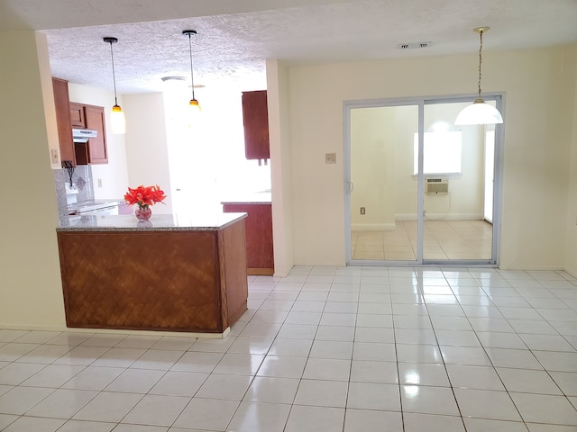 9206 Beringwood Dr, Houston, TX 77083 - kitchen featuring ventilation hood, a textured ceiling, hanging light fixtures, and light tile patterned floors