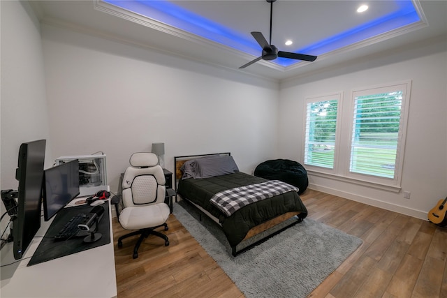 14646 Whistling Oak Dr, Conroe, TX 77356 - bedroom with a tray ceiling, crown molding, hardwood / wood-style flooring, recessed lighting, and a ceiling fan