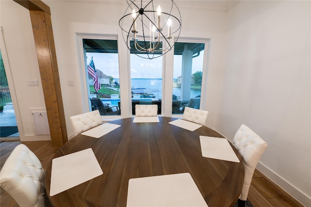 14646 Whistling Oak Dr, Conroe, TX 77356 - unfurnished dining area featuring a chandelier, wood finished floors, and ornamental molding