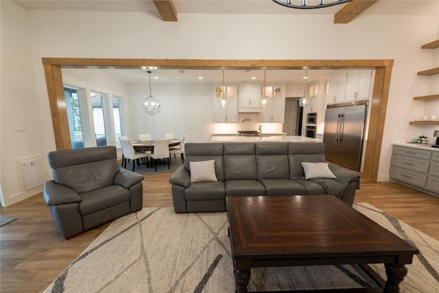 14646 Whistling Oak Dr, Conroe, TX 77356 - living room featuring beam ceiling and light wood-style floors