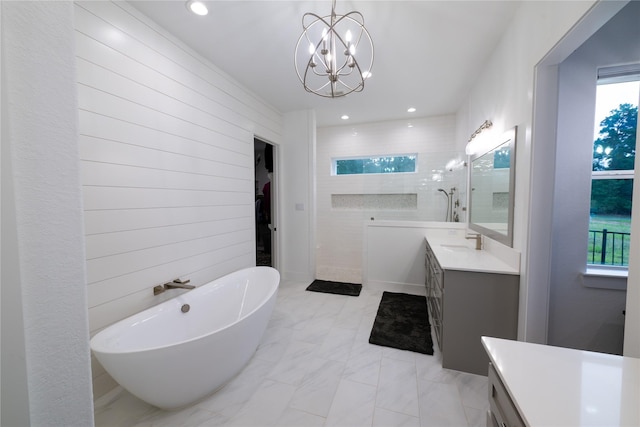 14646 Whistling Oak Dr, Conroe, TX 77356 - full bath with vanity, walk in shower, a freestanding tub, a chandelier, and marble look tiles