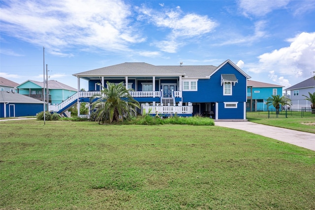973 Kenlyn Dr, Crystal Beach, TX 77650 - view of front of house with a front yard, driveway, and stairs