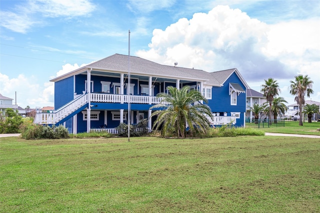 973 Kenlyn Dr, Crystal Beach, TX 77650 - rear view of house featuring a yard and stairway