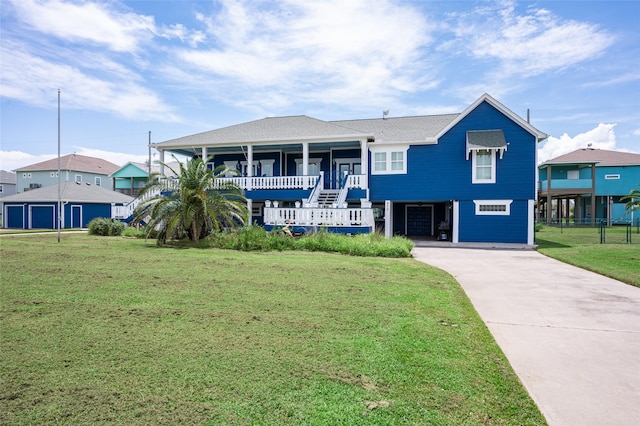 973 Kenlyn Dr, Crystal Beach, TX 77650 - coastal inspired home featuring driveway, a front yard, a carport, and covered porch