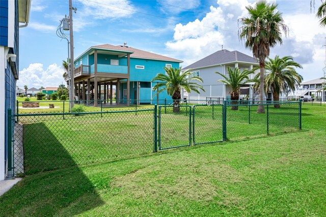 973 Kenlyn Dr, Crystal Beach, TX 77650 - view of yard with a gate, a balcony, and a carport