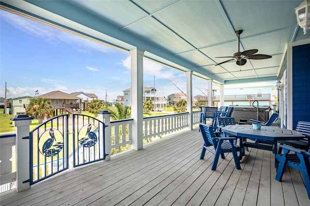 973 Kenlyn Dr, Crystal Beach, TX 77650 - deck with a hot tub, a residential view, a ceiling fan, and outdoor dining area