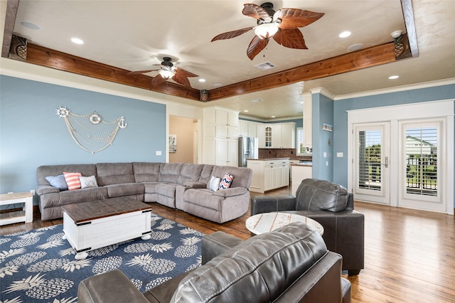973 Kenlyn Dr, Crystal Beach, TX 77650 - living area featuring ceiling fan, wood finished floors, recessed lighting, a raised ceiling, and ornamental molding