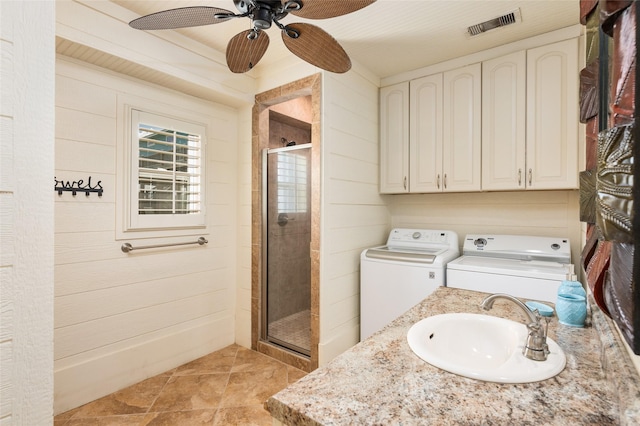 973 Kenlyn Dr, Crystal Beach, TX 77650 - bathroom with washer and clothes dryer, a shower stall, a ceiling fan, vanity, and wood walls
