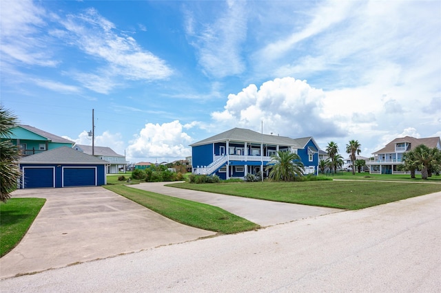 973 Kenlyn Dr, Crystal Beach, TX 77650 - beach home featuring concrete driveway, a front yard, a residential view, and stairs