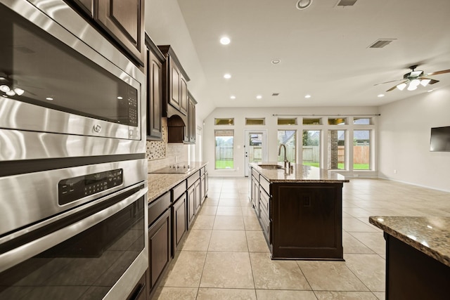 1303 Paradise Creek Ln, Rosenberg, TX 77471 - kitchen with appliances with stainless steel finishes, decorative backsplash, plenty of natural light, light stone counters, and recessed lighting