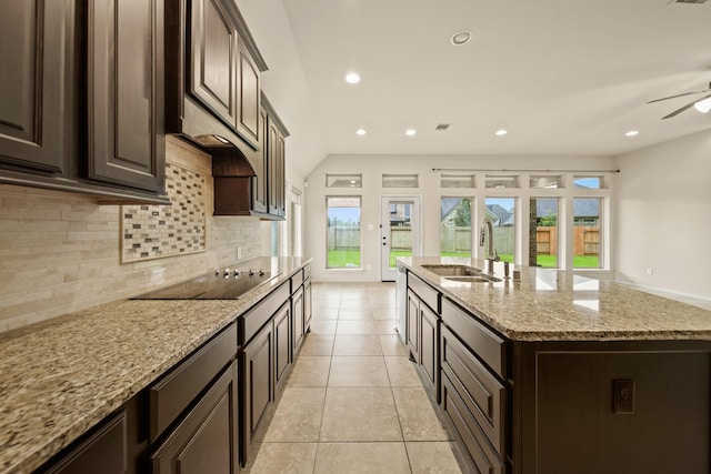 1303 Paradise Creek Ln, Rosenberg, TX 77471 - kitchen featuring black electric cooktop, tasteful backsplash, healthy amount of natural light, light tile patterned floors, and recessed lighting