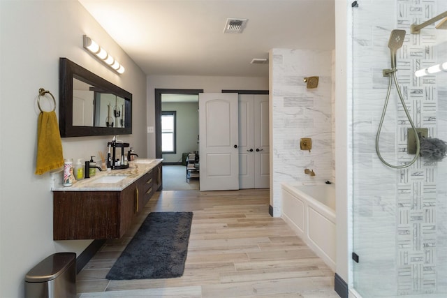 510 Jerry St, Houston, TX 77022 - full bath with a shower, double vanity, wood finished floors, and a bathtub
