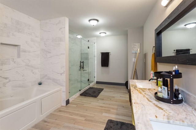 510 Jerry St, Houston, TX 77022 - bathroom with a stall shower, wood finished floors, a garden tub, and double vanity