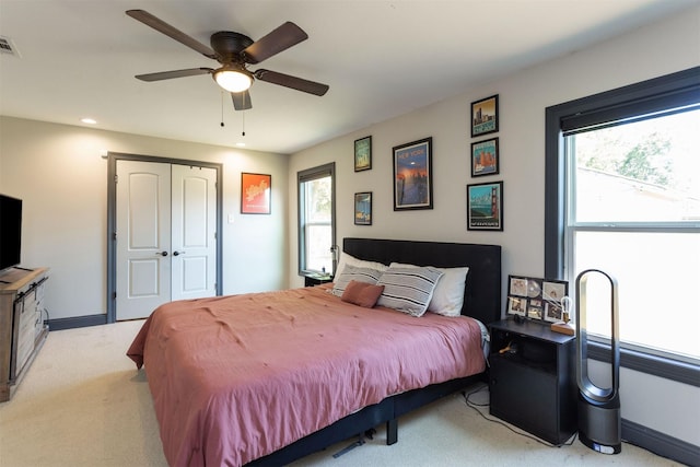510 Jerry St, Houston, TX 77022 - bedroom with light carpet, multiple windows, recessed lighting, a ceiling fan, and a closet