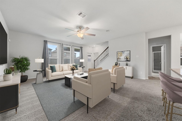 11103 Larkspur Dale Ct, Houston, TX 77044 - living room with light carpet, a ceiling fan, and stairs