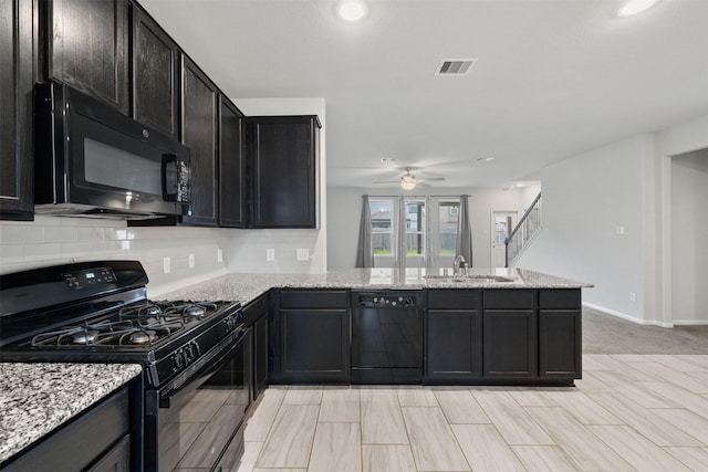 11103 Larkspur Dale Ct, Houston, TX 77044 - kitchen featuring black appliances, ceiling fan, a peninsula, backsplash, and light stone countertops