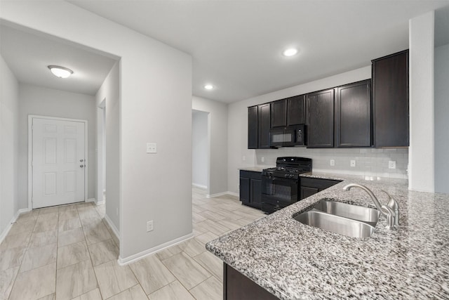 11103 Larkspur Dale Ct, Houston, TX 77044 - kitchen featuring black appliances, light stone counters, backsplash, recessed lighting, and dark brown cabinetry