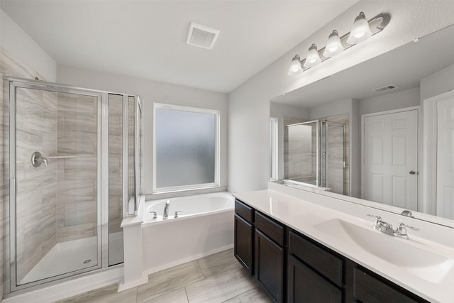 11103 Larkspur Dale Ct, Houston, TX 77044 - bathroom with vanity, a garden tub, and a shower stall