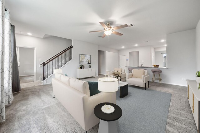 11103 Larkspur Dale Ct, Houston, TX 77044 - carpeted living area with stairs, a ceiling fan, and recessed lighting