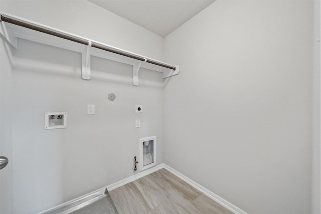 11103 Larkspur Dale Ct, Houston, TX 77044 - laundry room featuring hookup for a gas dryer, hookup for an electric dryer, hookup for a washing machine, and light wood-type flooring