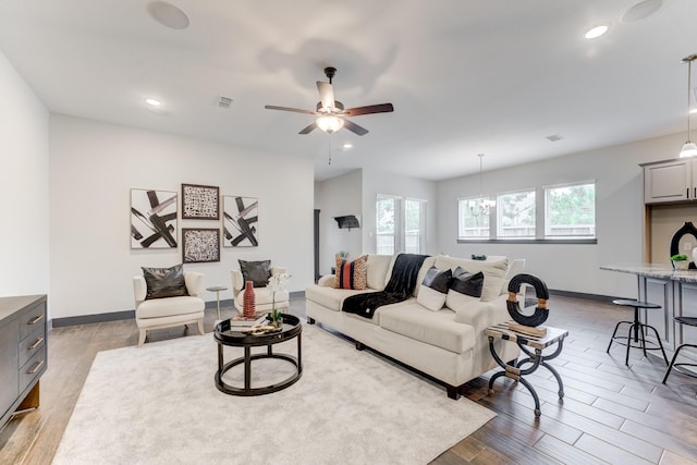28723 Eden Creek Trl, Fulshear, TX 77441 - living room with light wood-type flooring, ceiling fan, recessed lighting, and a chandelier