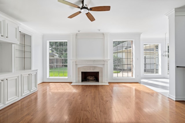 4919 Glen Hollow St, Sugar Land, TX 77479 - unfurnished living room featuring ceiling fan, light wood-style floors, a premium fireplace, and ornamental molding