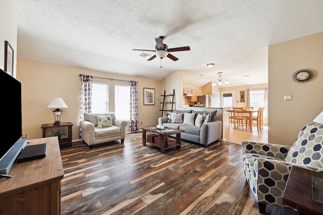 7238 Cypress Prairie Dr, Cypress, TX 77433 - living area featuring dark wood finished floors, ceiling fan, healthy amount of natural light, a textured ceiling, and a chandelier