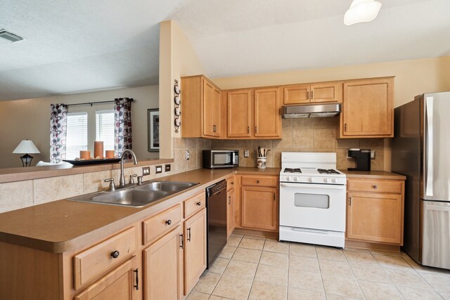 7238 Cypress Prairie Dr, Cypress, TX 77433 - kitchen featuring stainless steel appliances, under cabinet range hood, tasteful backsplash, a peninsula, and light brown cabinets