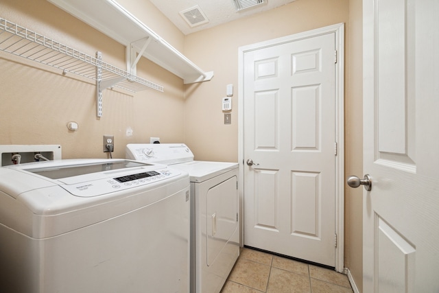 7238 Cypress Prairie Dr, Cypress, TX 77433 - washroom featuring separate washer and dryer and light tile patterned flooring
