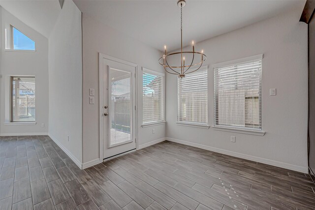 8934 Stanley Oak Dr, Missouri City, TX 77459 - unfurnished dining area featuring a chandelier, plenty of natural light, and dark wood-type flooring