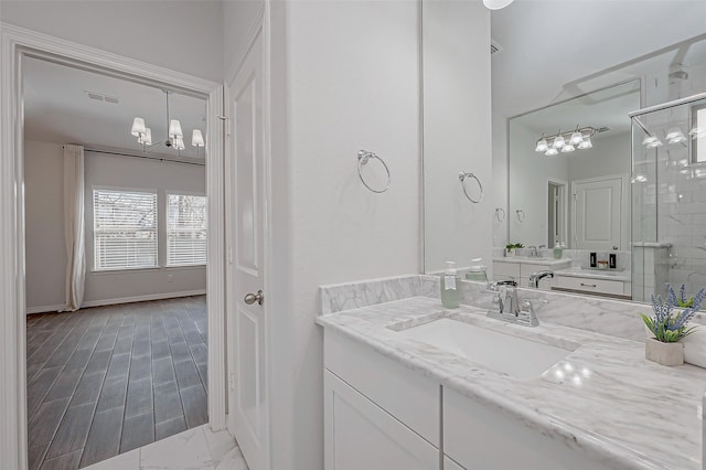 8934 Stanley Oak Dr, Missouri City, TX 77459 - full bathroom with a chandelier, vanity, a stall shower, and marble finish flooring